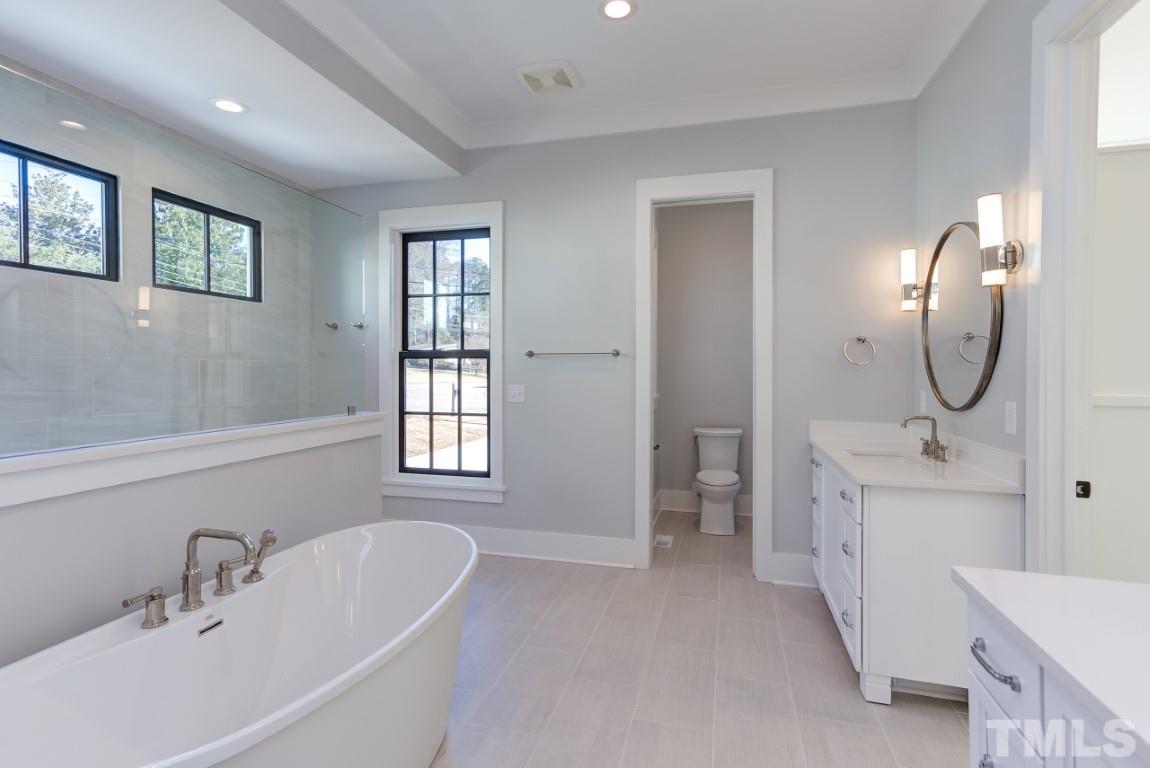 612 Shelley Road Raleigh, NC 27609 - Photo 7 of 19 a spacious bathroom with a tub sink and mirror