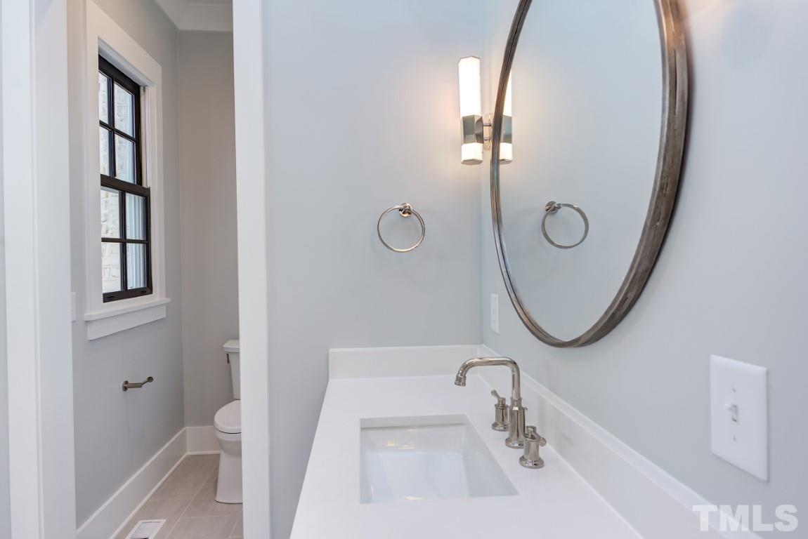 612 Shelley Road Raleigh, NC 27609 - Photo 8 of 19 a bathroom with a sink and mirror