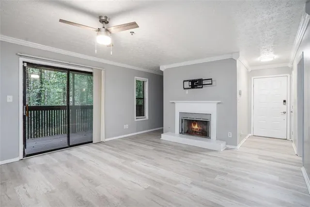 a view of a livingroom with a fireplace and windows
