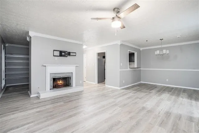 a view of an empty room with a fireplace and a window