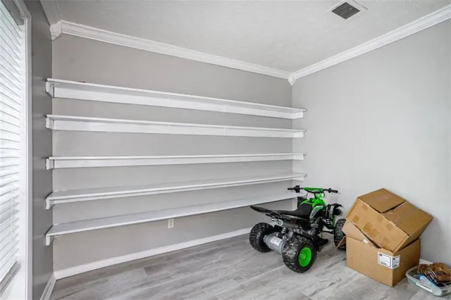 a dining room with furniture and a potted plant