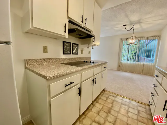 a kitchen with granite countertop a sink and a stove