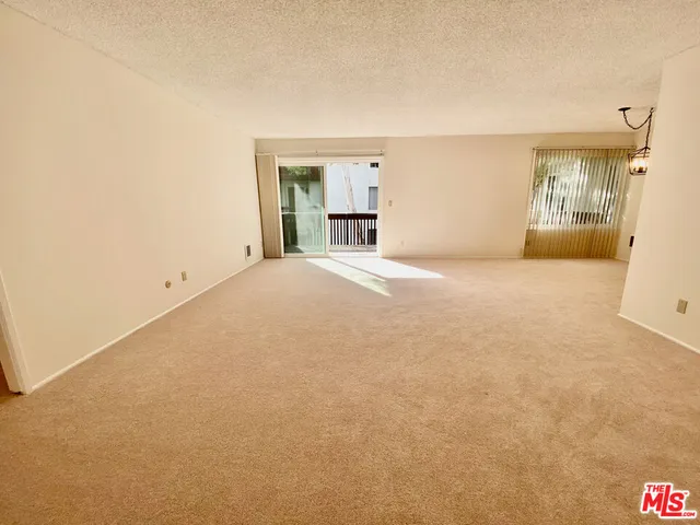 a view of an empty room with walk in closet