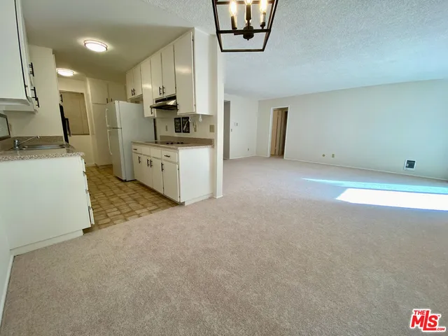 a large kitchen with stainless steel appliances granite countertop a sink and cabinets