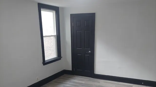 an empty room with windows and closet