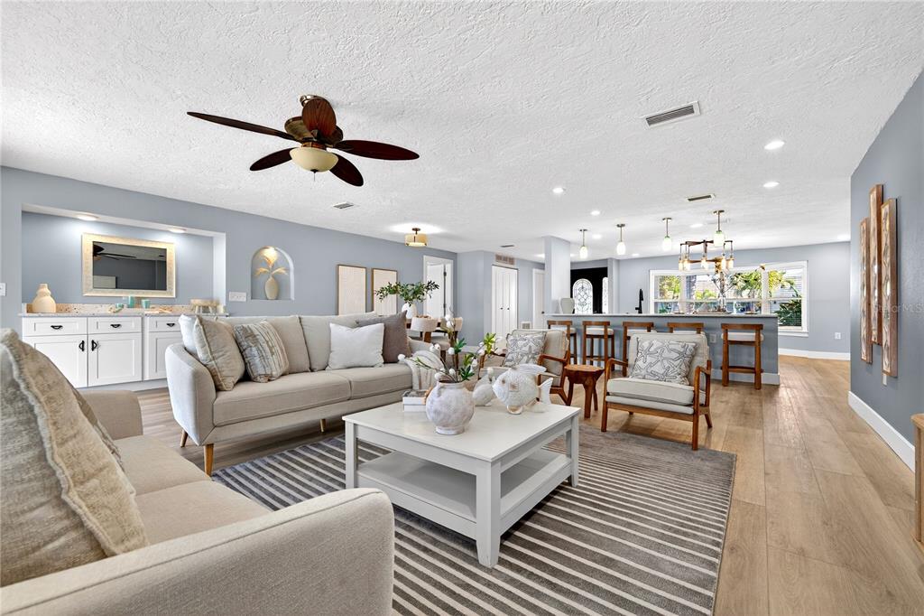 6410 3rd Palm Point St. Pete Beach, FL 33706 - Photo 13 of 71 a living room with furniture kitchen view and a wooden floor