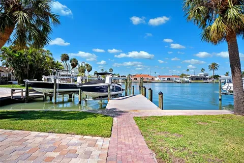 a view of a swimming pool with a lawn chairs and a fire pit