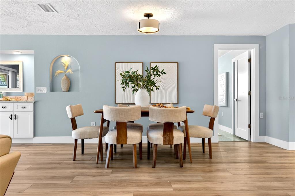 6410 3rd Palm Point St. Pete Beach, FL 33706 - Photo 15 of 71 a dining room with furniture a window and wooden floor