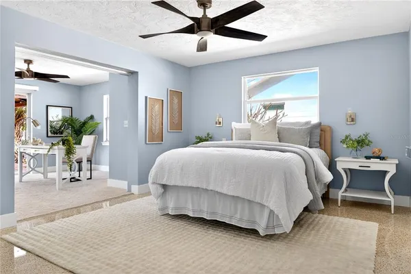 a living room with furniture and a potted plant