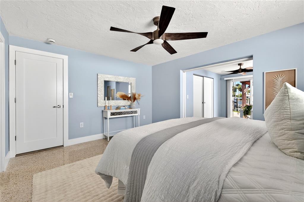 6410 3rd Palm Point St. Pete Beach, FL 33706 - Photo 17 of 71 a spacious bedroom with a bed and a large mirror