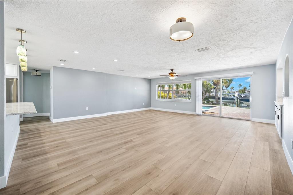 6410 3rd Palm Point St. Pete Beach, FL 33706 - Photo 19 of 54 a view of an empty room with wooden floor and a window