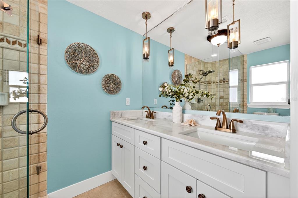 6410 3rd Palm Point St. Pete Beach, FL 33706 - Photo 22 of 71 a bathroom with a double vanity sink and a mirror