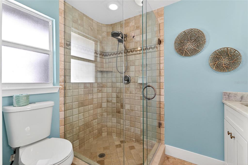 6410 3rd Palm Point St. Pete Beach, FL 33706 - Photo 23 of 71 a bathroom with a toilet a sink and shower