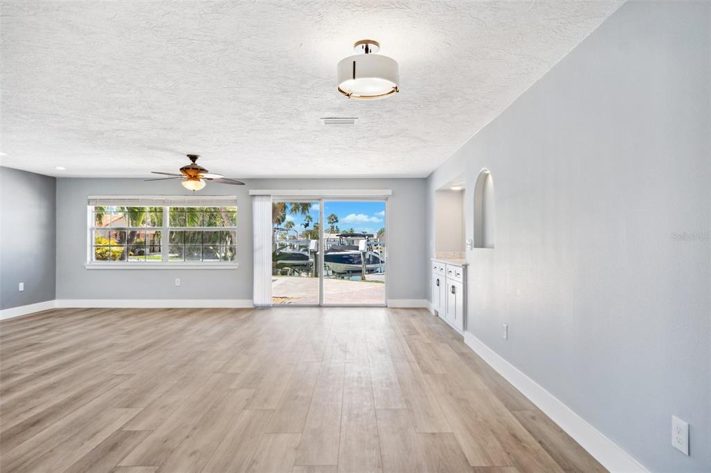 6410 3rd Palm Point St. Pete Beach, FL 33706 - Photo 23 of 54 a view of an empty room with a window and wooden floor
