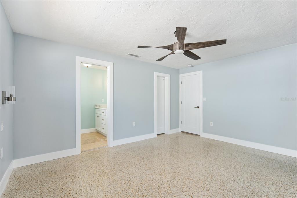 6410 3rd Palm Point St. Pete Beach, FL 33706 - Photo 25 of 54 an empty room with a ceiling fan and carpet