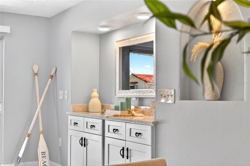 6410 3rd Palm Point St. Pete Beach, FL 33706 - Photo 26 of 71 a bathroom with a sink vanity and a mirror