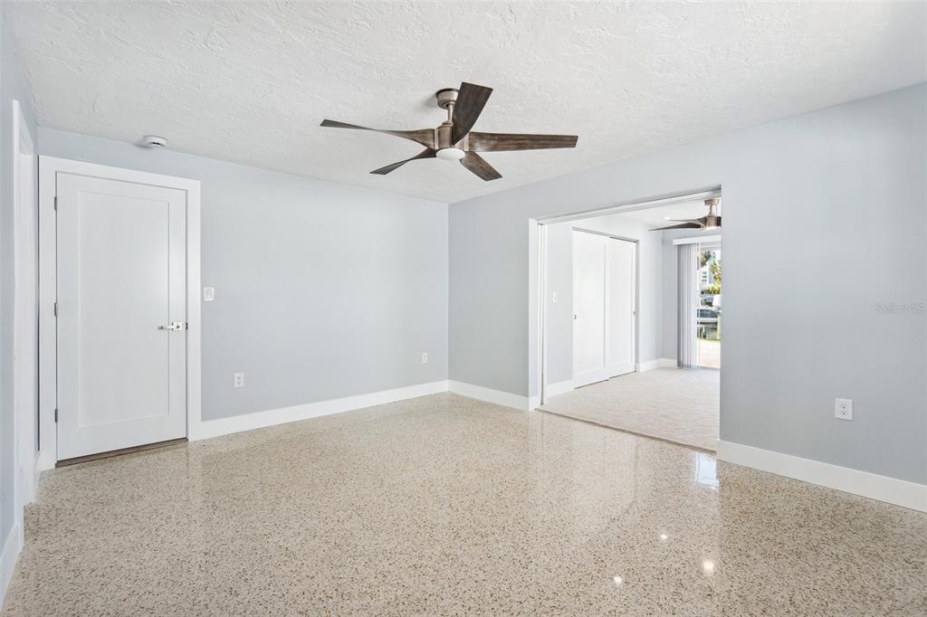 6410 3rd Palm Point St. Pete Beach, FL 33706 - Photo 26 of 54 an empty room with windows and fan