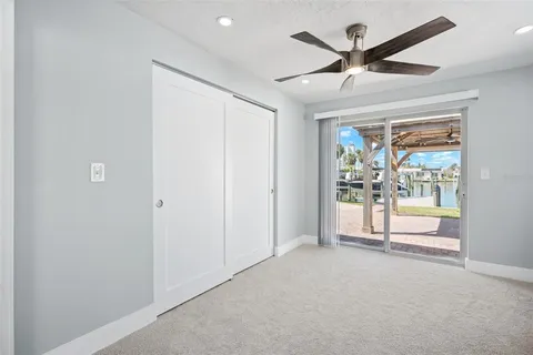 a view of a livingroom with a ceiling fan & entryway