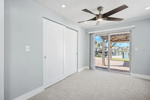 a view of a livingroom with a ceiling fan & entryway