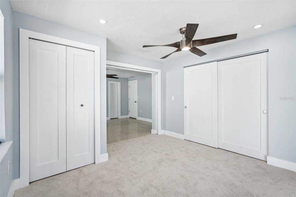 6410 3rd Palm Point St. Pete Beach, FL 33706 - Photo 30 of 54 a view of a livingroom with a ceiling fan & entryway