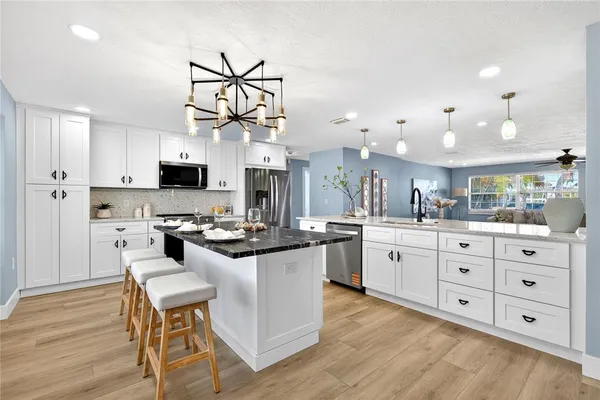 a kitchen with white cabinets and stainless steel appliances