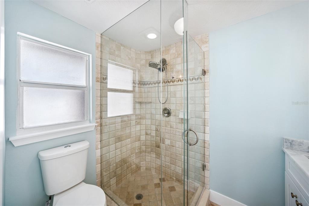 6410 3rd Palm Point St. Pete Beach, FL 33706 - Photo 33 of 54 a bathroom with a shower and toilet