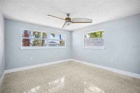 a bathroom with double vanity sinks a large mirror and a window