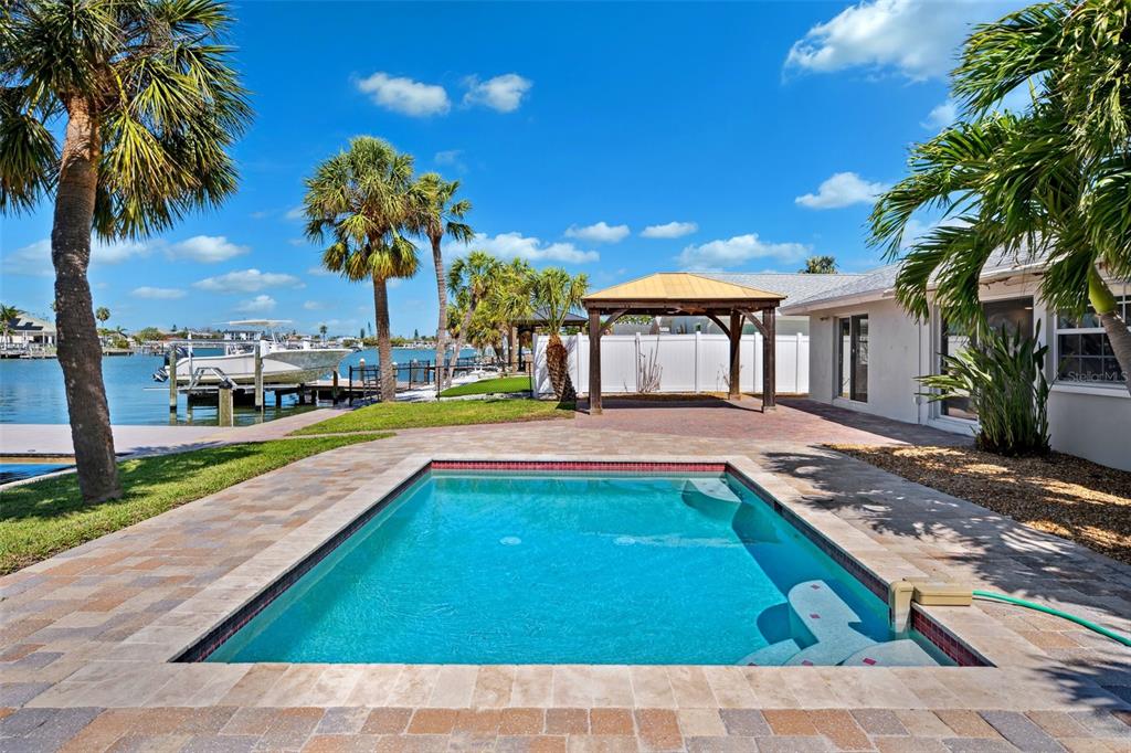 6410 3rd Palm Point St. Pete Beach, FL 33706 - Photo 35 of 71 a view of a house with swimming pool