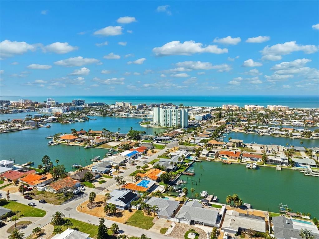 6410 3rd Palm Point St. Pete Beach, FL 33706 - Photo 42 of 71 an aerial view of a city with lots of residential buildings ocean and ocean view