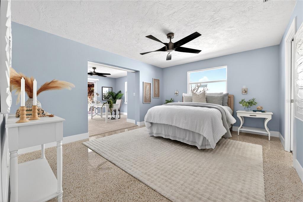 6410 3rd Palm Point St. Pete Beach, FL 33706 - Photo 53 of 71 a bedroom with a bed and a chandelier