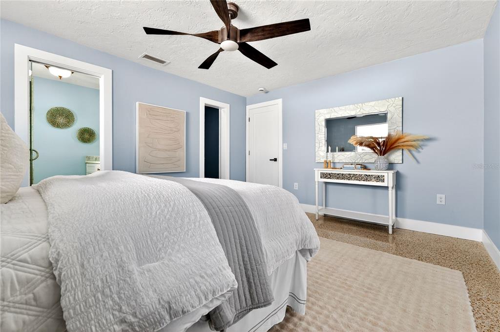 6410 3rd Palm Point St. Pete Beach, FL 33706 - Photo 55 of 71 a bedroom with a bed and a chandelier