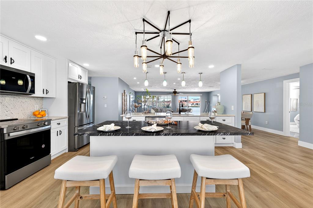 6410 3rd Palm Point St. Pete Beach, FL 33706 - Photo 58 of 71 a large kitchen with a table and chairs