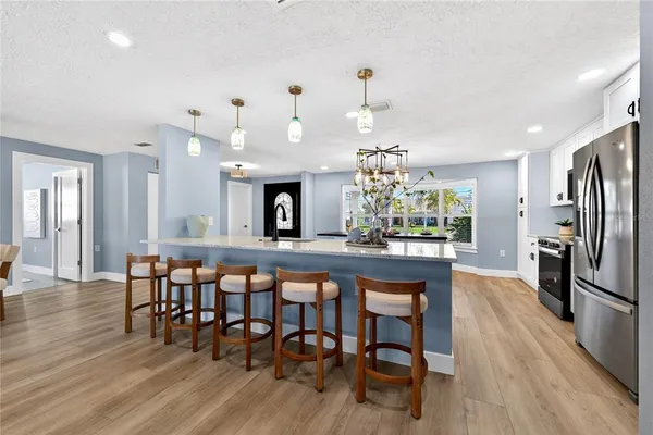 a kitchen with stainless steel appliances a stove top oven and a refrigerator