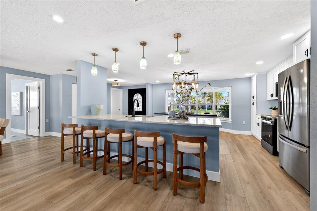 6410 3rd Palm Point St. Pete Beach, FL 33706 - Photo 7 of 71 a view of a dining room with furniture window and wooden floor