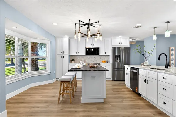 a view of swimming pool with outdoor seating and a garden