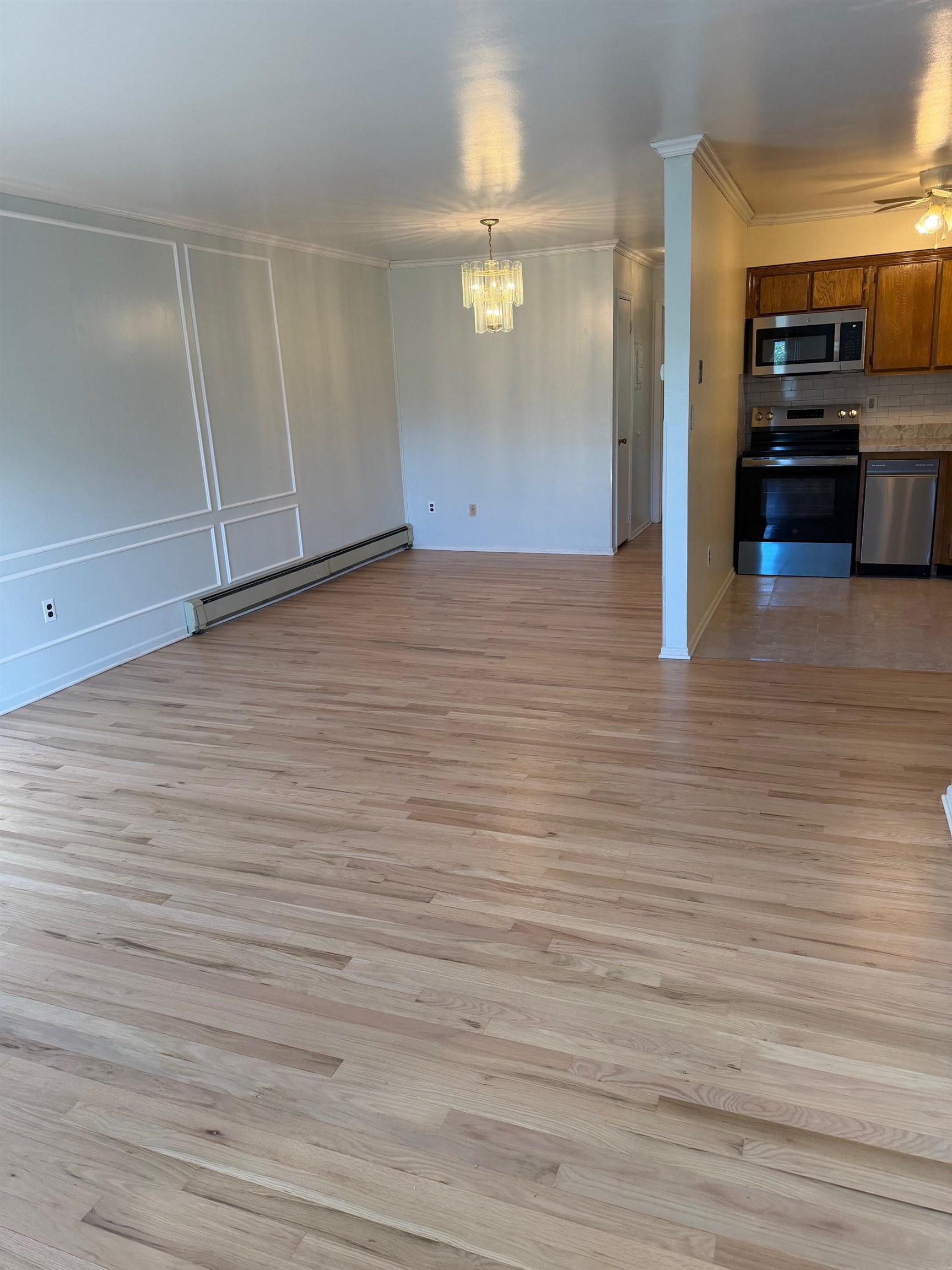 729 10th Street, Unit 3D Secaucus, NJ 07094 - Photo 2 of 7 a view of a refrigerator in kitchen and an empty room