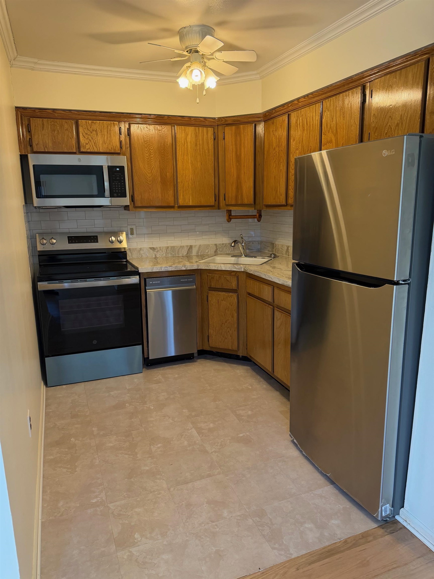 729 10th Street, Unit 3D Secaucus, NJ 07094 - Photo 3 of 7 a kitchen with granite countertop a refrigerator and a stove top oven