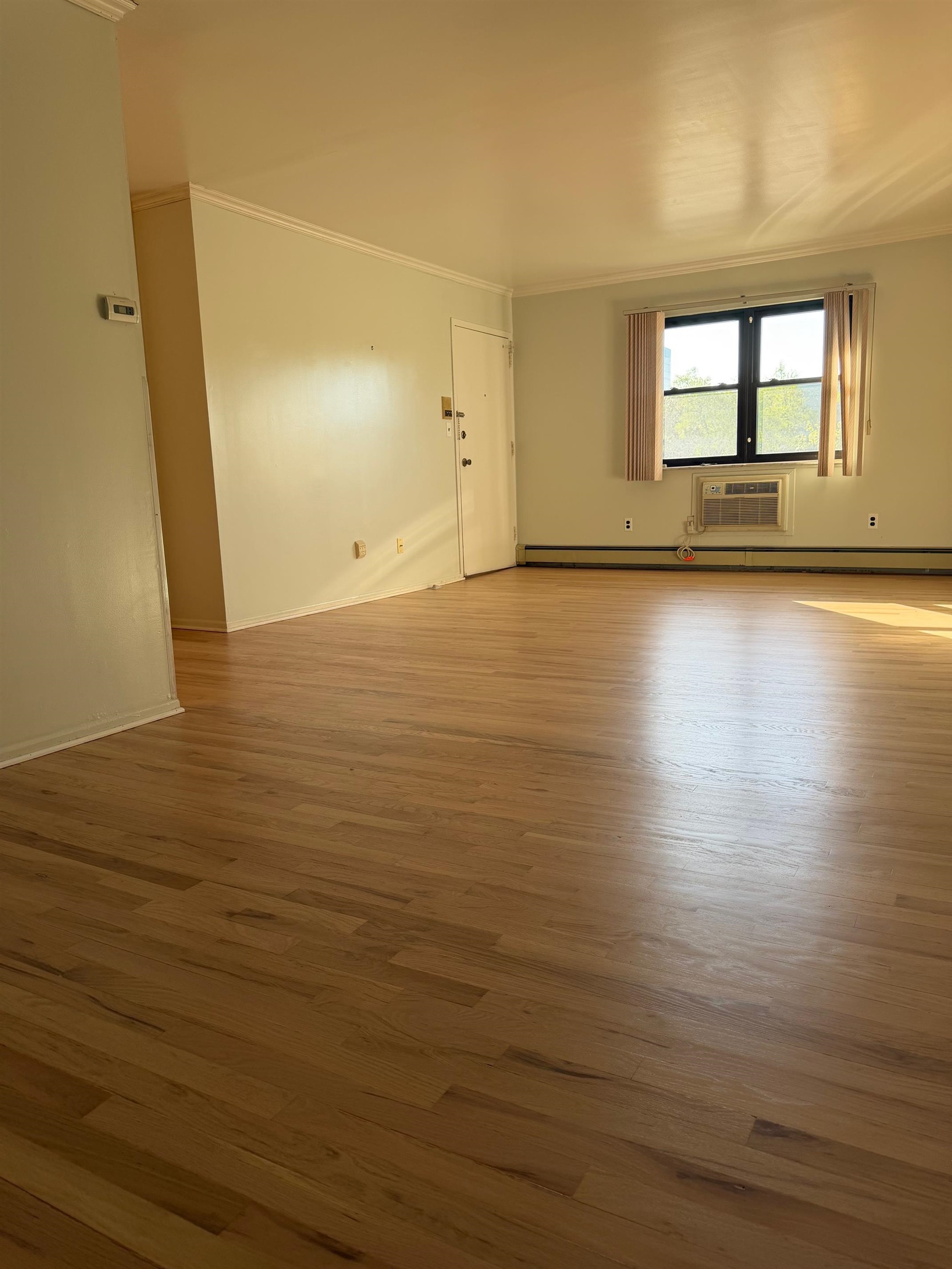729 10th Street, Unit 3D Secaucus, NJ 07094 - Photo 7 of 7 an empty room with wooden floor and windows