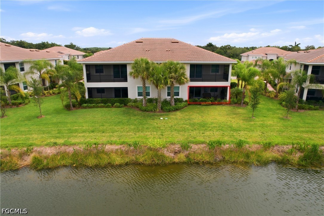 3751 Pebblebrook Ridge Court, Unit 101 Fort Myers, FL 33905 - Photo 45 of 48 a view of a patio with a table and chairs under an umbrella