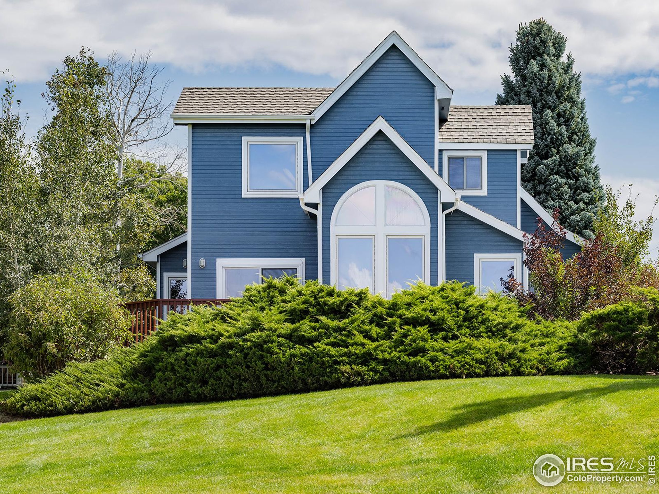 a front view of a house with a garden
