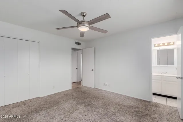 a view of a livingroom with a ceiling fan and window