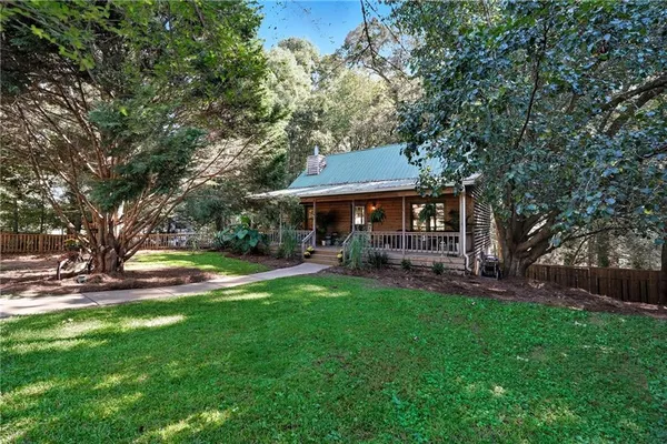 a view of a house with a yard porch and sitting area