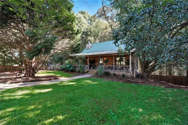a view of a house with a yard porch and sitting area