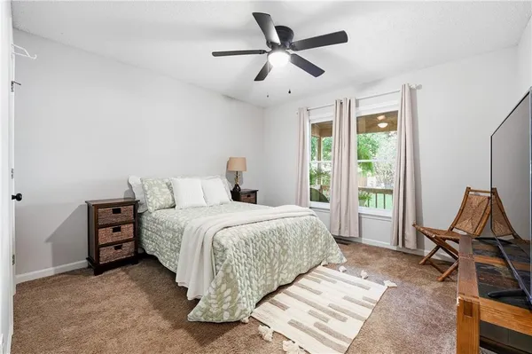 a bed room with a bed window and a chandelier