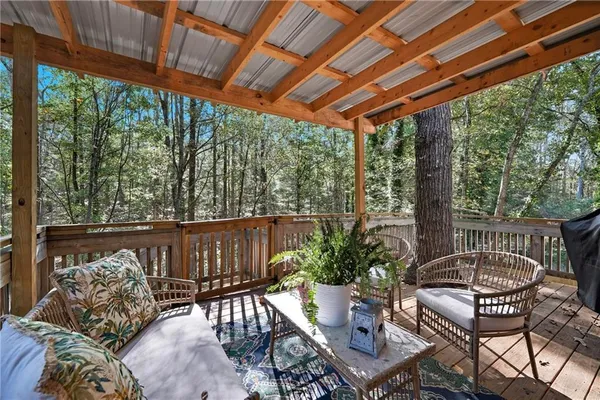 a view of a patio with furniture and a backyard