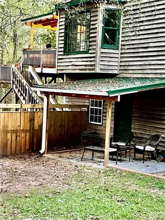 a backyard of a house with barbeque oven table and chairs