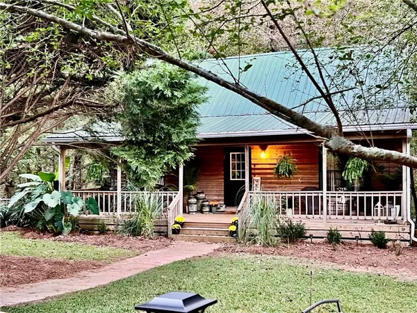 a view of a chair and table in backyard of the house