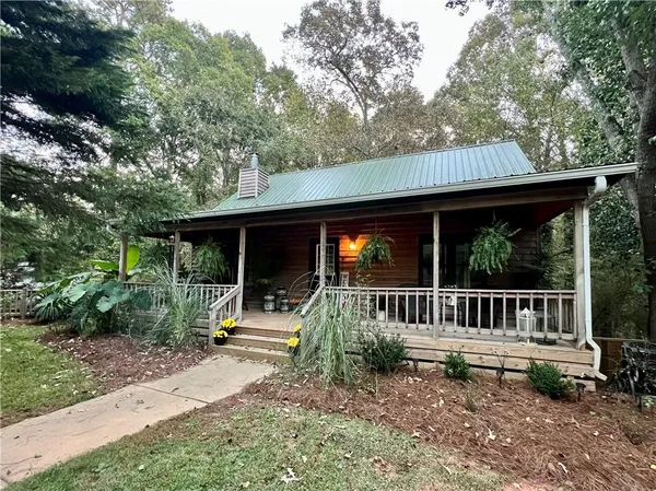 a view of a house with backyard and sitting area