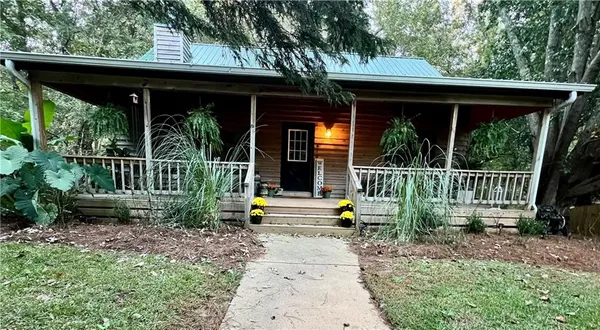 a front view of a house with porch and furniture