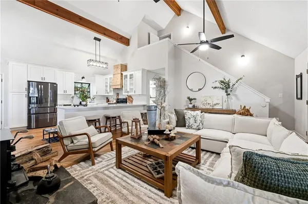 a living room with lots of furniture and a chandelier